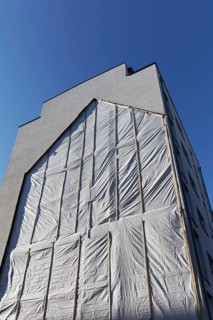 Fire wall with outline of a demolished house
