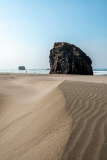 Sandy beach beach with sea and big rocks