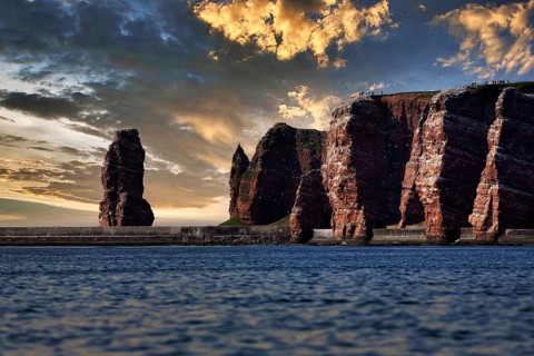 View from the sea to the rocky island of Helgoland with surf pillar Lange Anna
