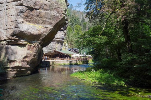Resting place at the log cabin and rock walls in the Kamenice valley