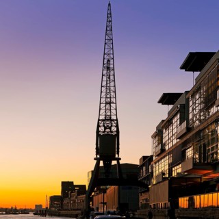 Crane at the fishing harbour at sunset