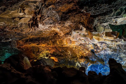 Colourfully illuminated areas of the Cueva de los Verdes