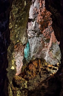 Colourfully illuminated areas of the Cueva de los Verdes