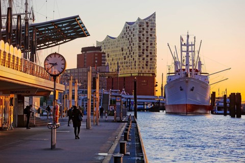 Elbe Philharmonic Hall with the museum ship Cap San Diego at sunrise