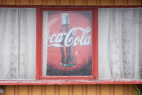 Old advertising sign for Coca-Cola in window