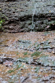 Water flowing down steep rock face