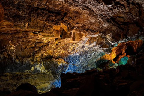 Colourfully illuminated areas of the Cueva de los Verdes