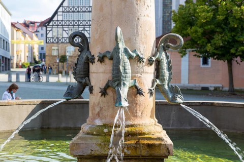 Dragon figures spit water in the market fountain on the market square