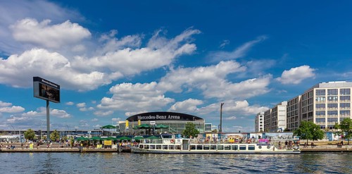Passenger boats on the Spree at the Mercedes Benz Sales Headquarters and the Mercedes Benz Arena