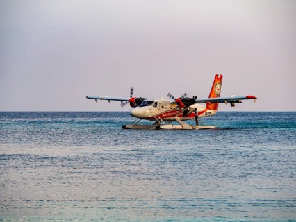 Seaplane landing in a lagoon of a Maldives island