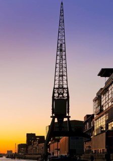 Crane at the fishing harbour at sunset