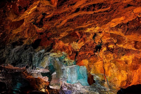 Colourfully illuminated areas of the Cueva de los Verdes