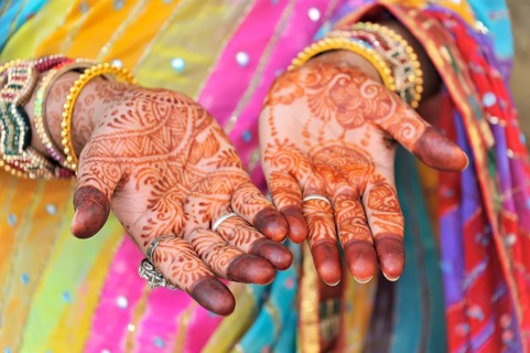 Festive henna painting of the hands of an Indian woman