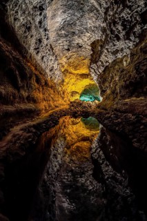 Colourfully illuminated areas of the Cueva de los Verdes