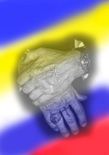 Two hands with tattoos and in the background the flags of Russia and Ukraine