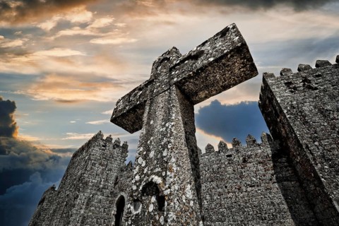 Cross next to castle walls