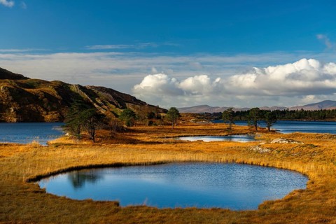 Lough Cloonee with cloudy sky in autumn landscape