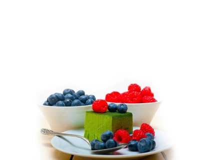 Green tea matcha mousse cake with raspberries and blueberries on top