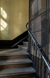Staircase and grid on a historic lift in an old factory
