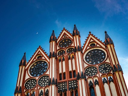 The moon shines over the facade of the town hall