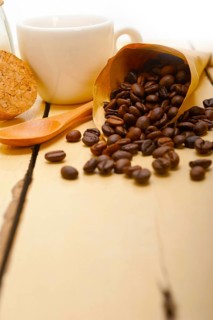 Espresso coffee and beans on a paper cone cornucopia over white background