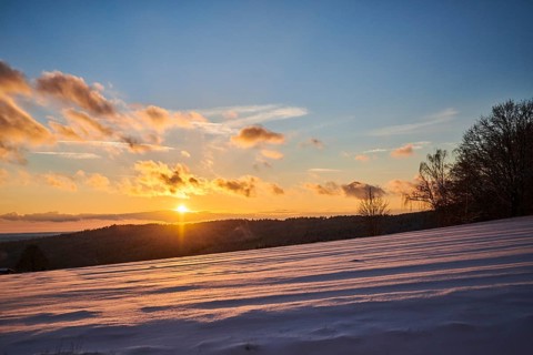Sunset over a field covered with snow near Wiesent