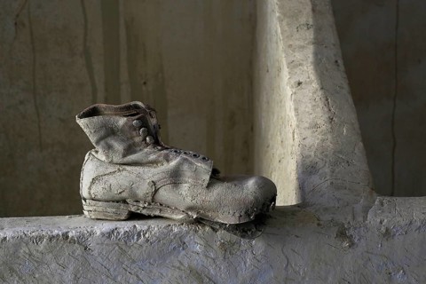 Leather work shoe on wall