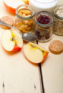 Healthy breakfast ingredients milk oat cashew nuts dried cramberry craisinns