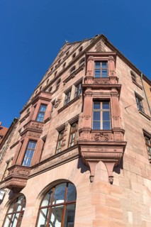 Residential and commercial building with double bay window in neo-Renaissance style