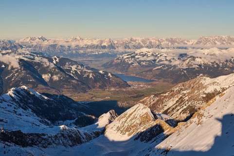 View from Mount Kitzsteinhorn on snow covered mountains down to Zell am See