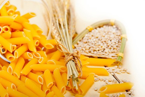 Short Italian pasta penne with durum wheat grains