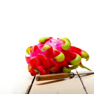 Fresh thai purple dragon fruit over white rustic table