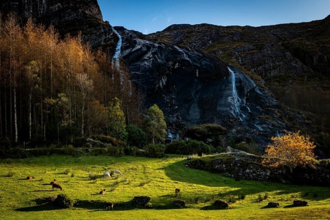 Waterfall in autumn landscape