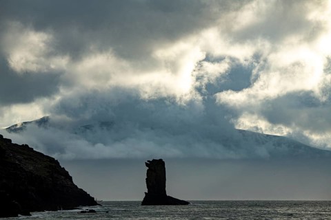 North Atlantic with rock needle and cloudy sky