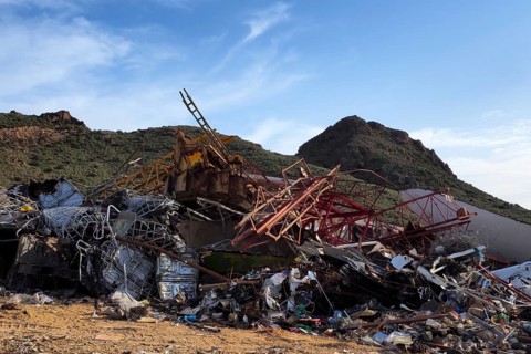Scrap piles in front of mountains