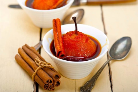 Poached pears delicious home made recipe ove white rustic wood table