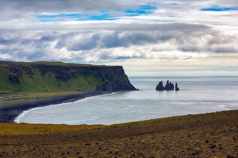Bay with cliffs and black lava beach Reynisfjara