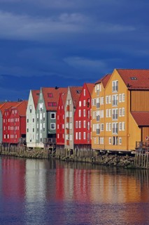 Wooden houses on stilts reflected in a body of water