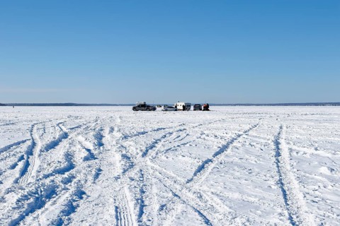 Tire tracks in snow on a frozen river