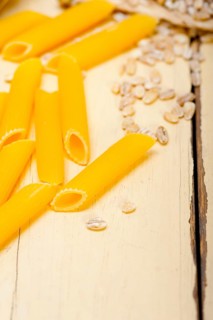 Short Italian pasta penne with durum wheat grains