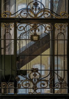 Decorated door and warning sign from a historic lift in an old factory