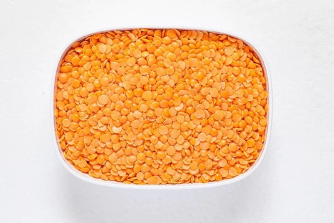 The red split lentil also known as Egyptian lentil or Masoor dal against white background