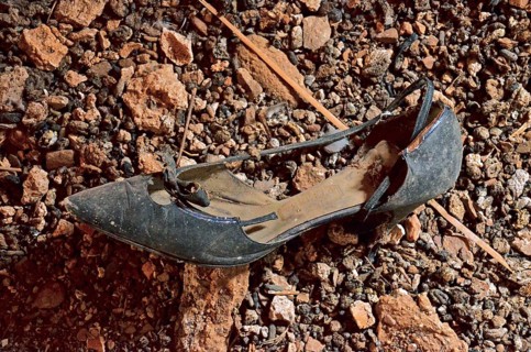 Black women's shoe with heel and bow at the bottom