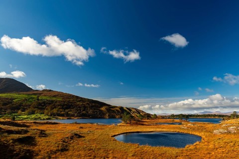 Lough Cloonee with cloudy sky in autumn landscape