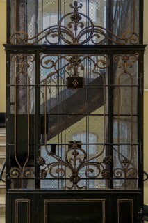 Ornate door from a historic lift in an old factory