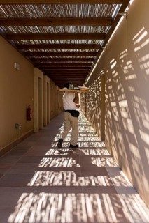 Room waiter with tablet in the corridor of a hotel