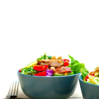 Fresh and healthy Chicken Avocado salad over rustic wood table