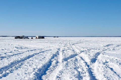 Tire tracks in snow on a frozen river