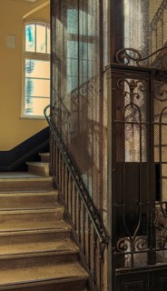 Ornate door from a historic lift in an old factory