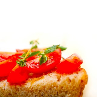 Italian tomato bruschetta with thyme and mint leaves